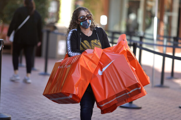 Woman carrying her shopping bags at the Citadel Outlet Mall in California