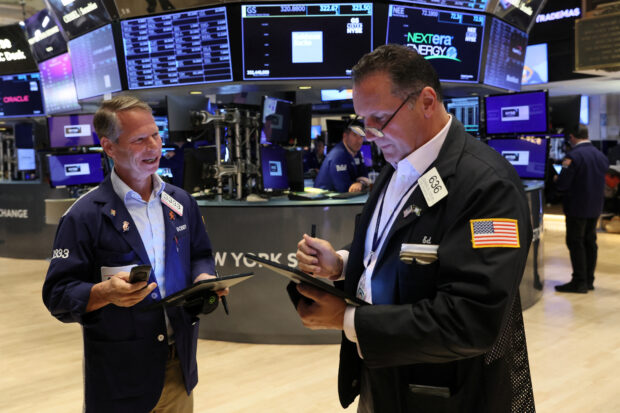 Traders work on the floor of NYSE
