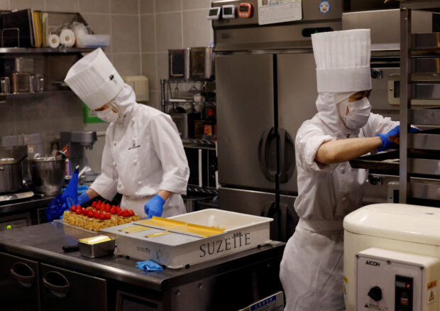 Employees of Suzette Holdings prepare cakes at a shop in Tokyo