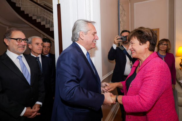 Argentina's Pesident Alberto Fernandez holds hand with IMF managing director Kristalina Georgieva