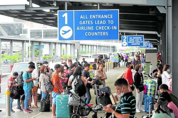 NORMALIZING   Passengers line up at the departure area of Ninoy Aquino International Airport as travel demand returns. —INQUIRER FILE PHOTO