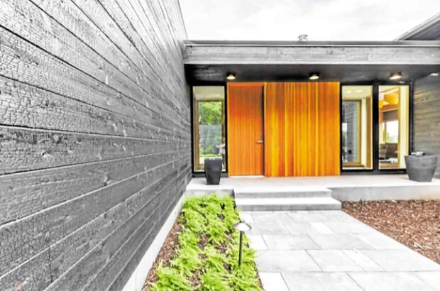 An entryway made dramatic with the natural timber finishes enhanced by its contrast to the charred wood (NAKAMOTO FOR- ESTRY)