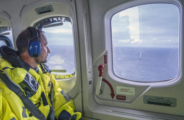 Norway's Crown Prince Haakon aboard a helicopter looks at the floating wind farm