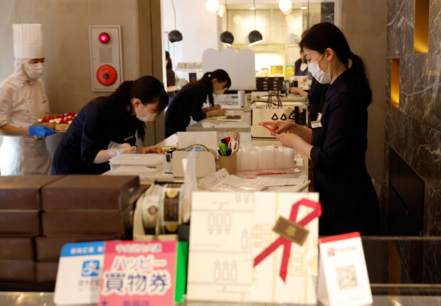 Employees work at a shop of Suzette Holdings Co. in Tokyo
