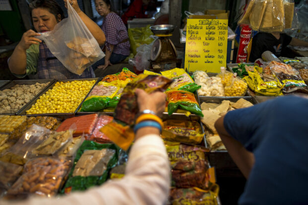 People shop for vegetarian food at a market in Chinatown, Bangkok