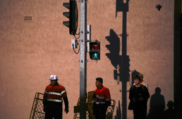 Workers carrying barriers 