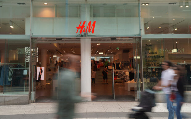People walk past a branch of H&M in Stockholm, Sweden