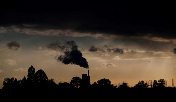 Smoke rises above a factory in Rugby, Britain