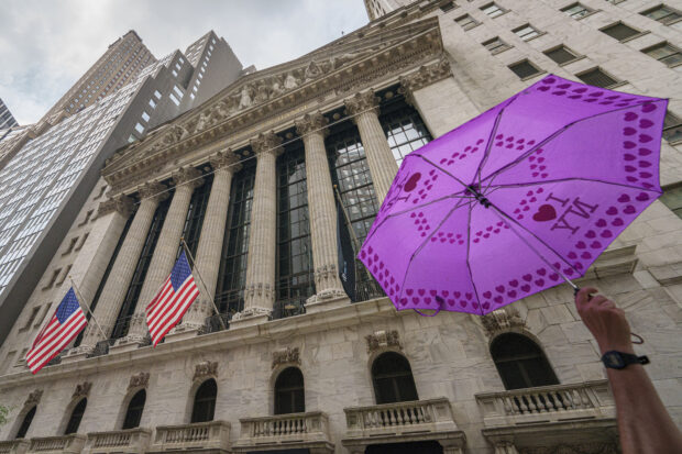 An umbrella held by a tour group leader seen in front of the NYSE 