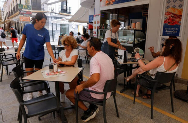 Waitresses attend to customers at a bar in Ronda, Spain