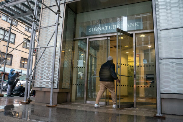 A man walking into a Signature Bank branch in New York