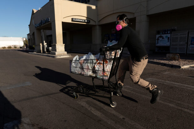 An Instacart employee heads to his car outside a Safeway grocery store in Arizona