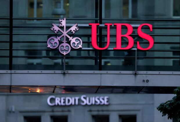 Logos of Swiss banks UBS and Credit Suisse