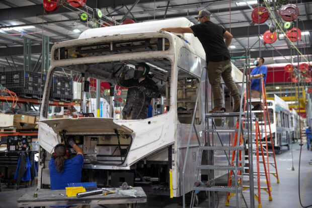 Workers build e-buses at the BYD factory in Lancaster,California