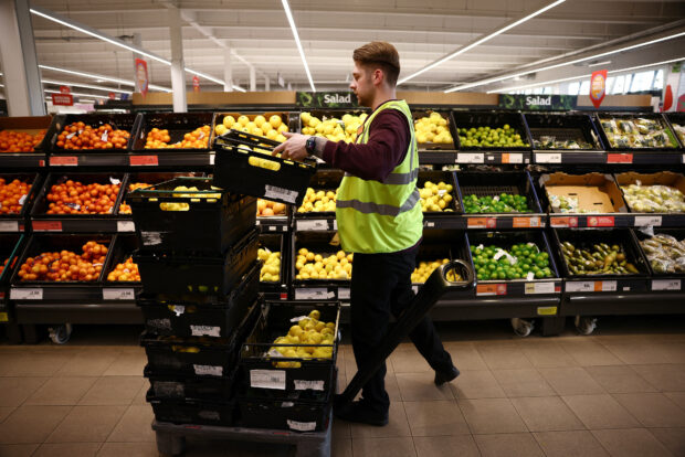 An employee arranges the produce in Salisbury's supermarket