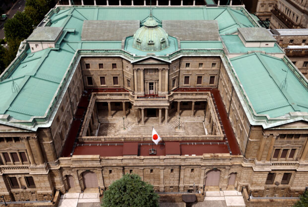 Japanese flag is hoisted atop the Bank of Japan building in Tokyo