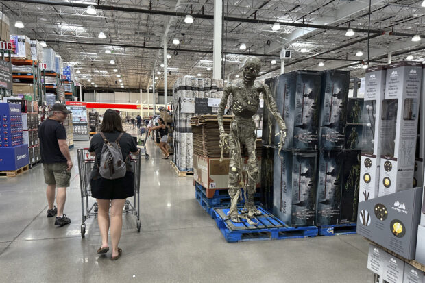 Consumer spending. Shoppers pass a display of Halloween goods at Costco in Colorado