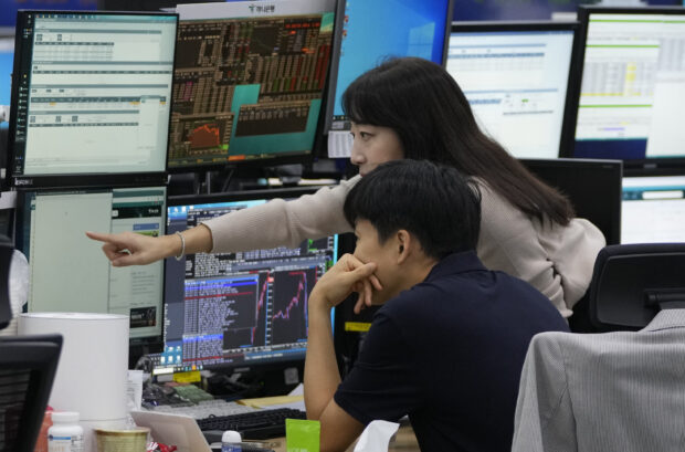 Currency traders watch monitors at a forex dealing room of the KEB Hana Bank in Seoul