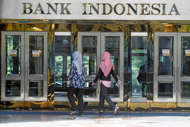 People walk toward the entrance io Indonesia's central bank building