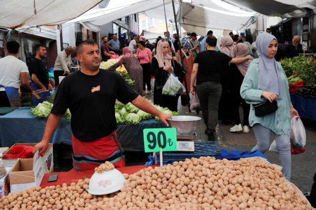 People shop at a fresh market in Istanbul