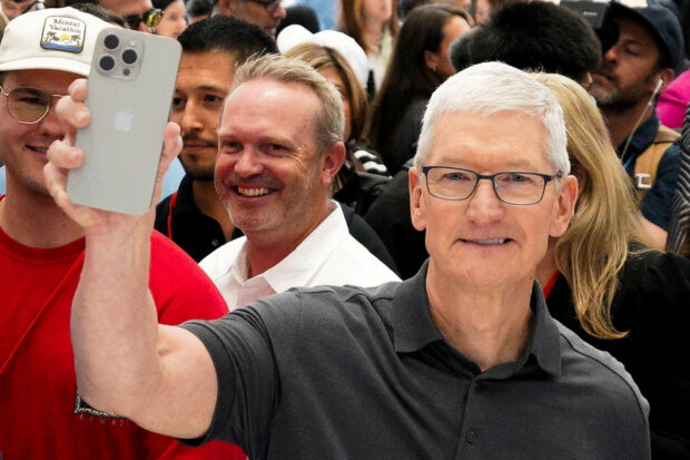 Apple CEO Tim Cook holds a new iPhone 15 Pro 