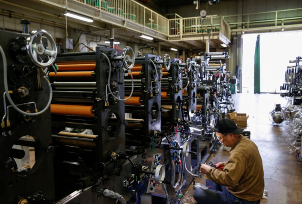 A worker checks machinery at a factory in Higashiosaka, Japan