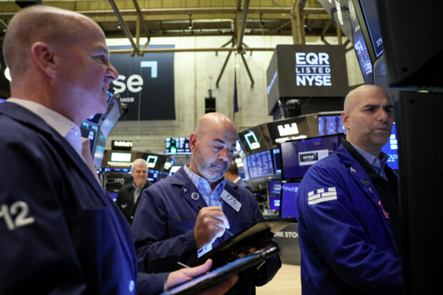 Traders work on the floor of the NYSE