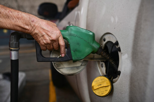 A worker pumps fuel at a gas station in Caracas, Venezuela