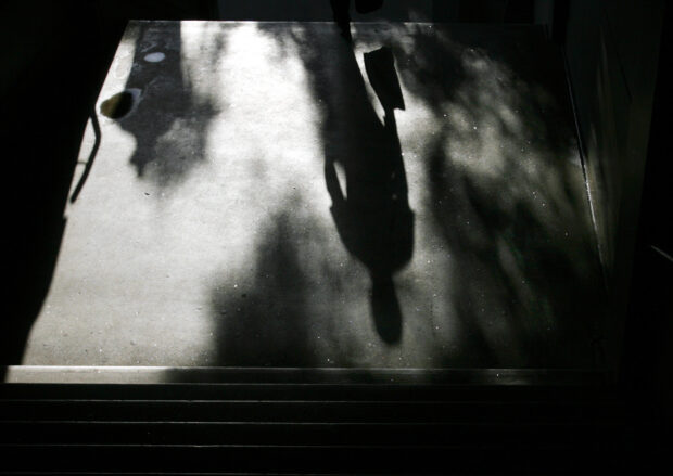An office worker casts a shadow as he climbs a set of steps in Sydney's central business district
