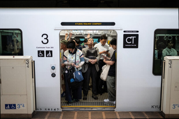 People travel on a subway in Fukuoka, Japan