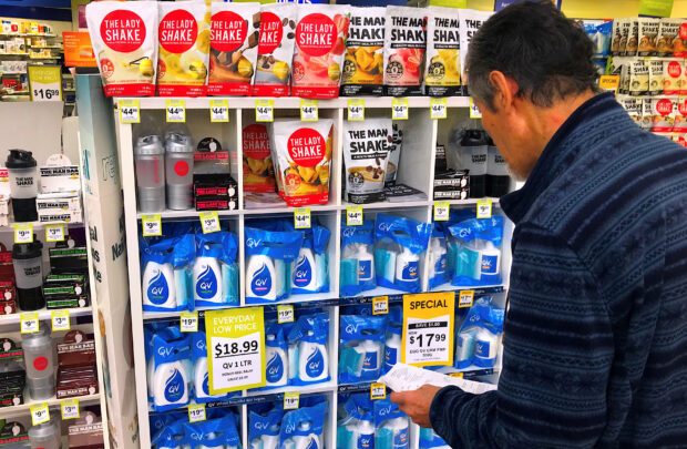 A customer checks products on display at a chemist in a shopping mall in central Sydney, Australia