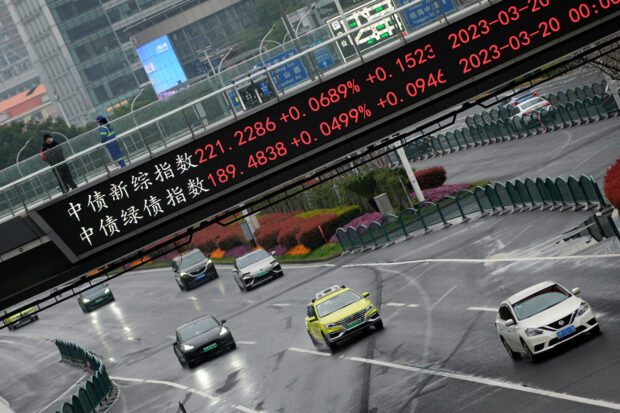 Electronic board shows stock indexes in financial district in Shanghai