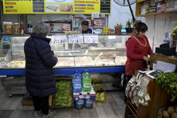 Customers shop at a greegrocer's in Buenos Aires