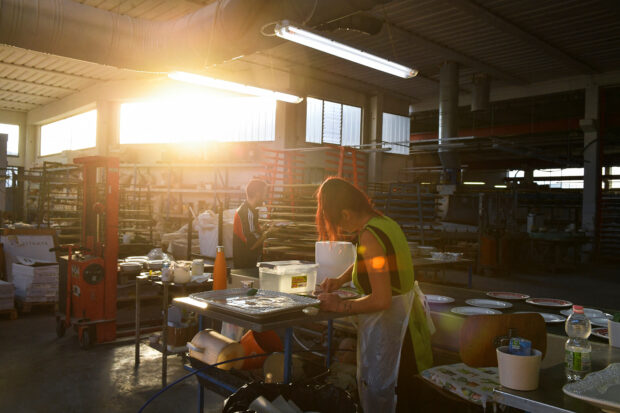 Employees work at a ceramics factory where the workers start their shifts in Citta di Castello, Italy