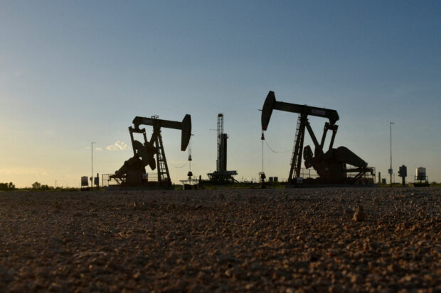 Pump jacks operate in an oil field in Midland , Texas