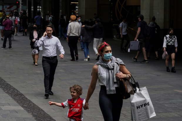 Pedestrians walk through a shopping plaza in Sydney