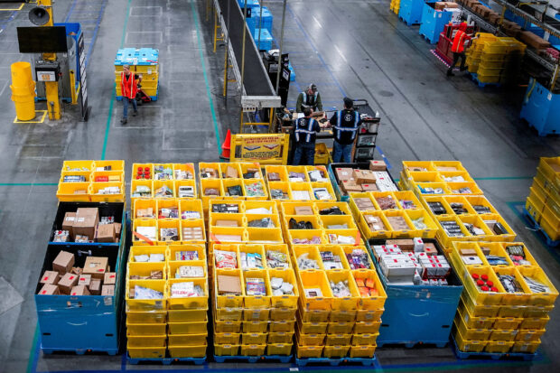 Workers pack items during at Amazon fulfilment center in New Jersey