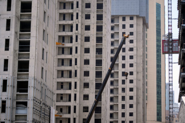 A crane amid residential buildings under construction in Shanghai