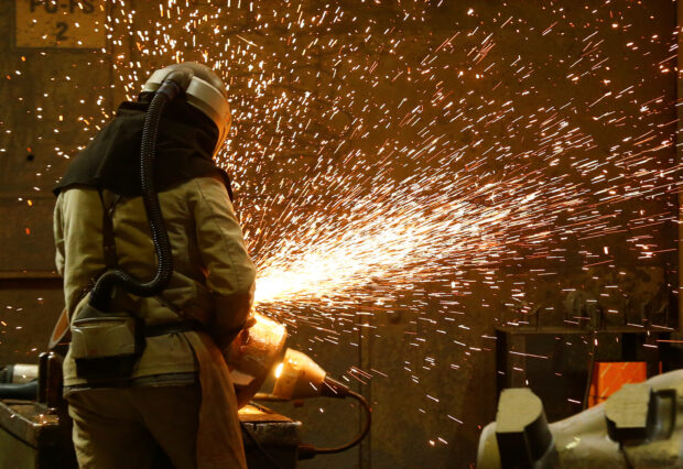 A steel worker grinds a steel cast in Muelheim an der Ruhr, Germany