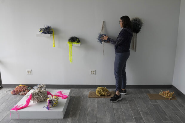 Bee Cups owner Jen Rose adjusts an installation at her office