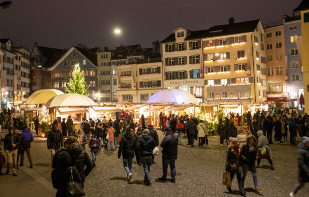 People walk at the Christmas market in Zurich
