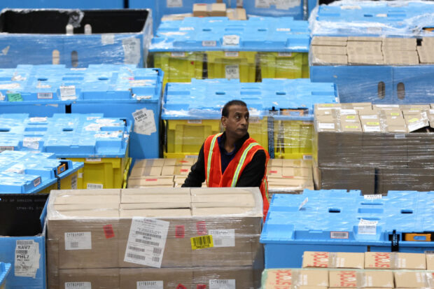 A worker check products at Amazon fulfillment center during Cyber Monday