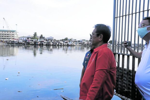DHSUD Secretary Jose Rizalino Acuzar, along with other DHSUD executives, inspects the riverbanks and nearby areas of Pasig River.