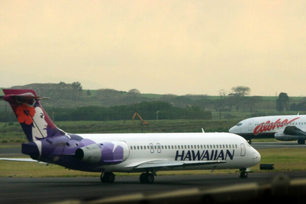 A Hawaiian Airlines plane taxis at Kahalui, Hawaii