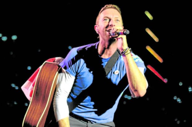 Chris Martin of British band Coldplay performingat SM Mall of Asia open grounds in 2017.