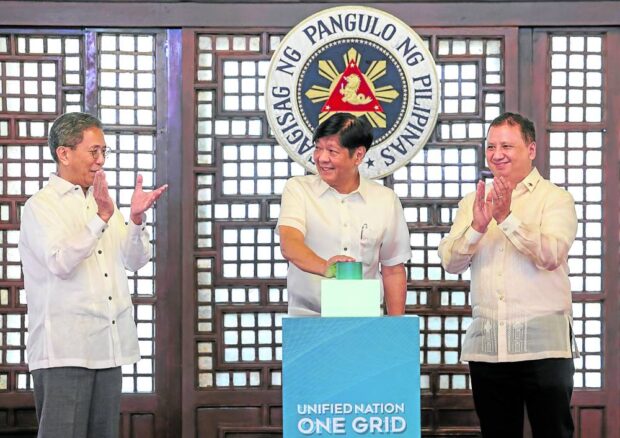 VOLT IN President Marcos (middle), Energy Secretary Raphael Lotilla (left) and NGCP president Anthony Almeda “switches on” the P51.3-billion Mindanao-Visayas Interconnection Project on Friday. —PHOTO COURTESY OF NGCP