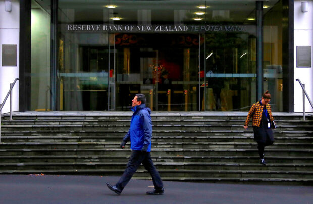NZ central bank holds rates, flags less hawkish policy track