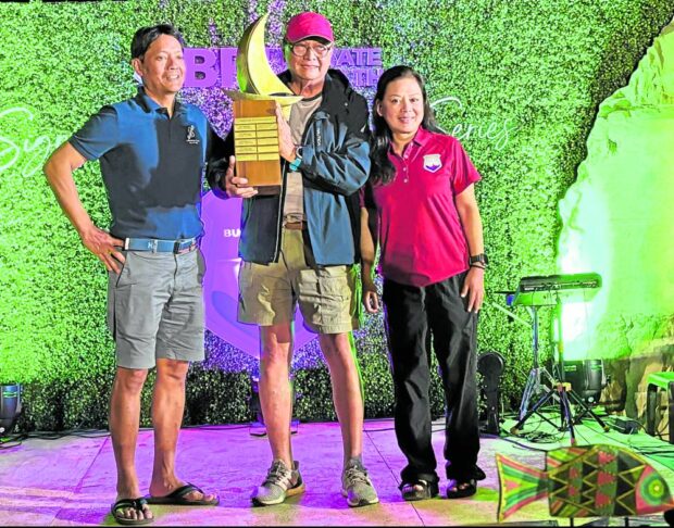 Karakoa skipper Ray Ordoveza (center)receives the Doni Altura Perpetual Trophy. With him are sailing veteran Altura and Tere Marcial, president and CEO of BPI Private Wealth.