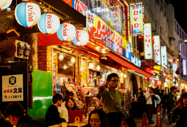People enjoy drinks and food at izakaya pub restaurants at the Ameyoko shopping district, in Tokyo