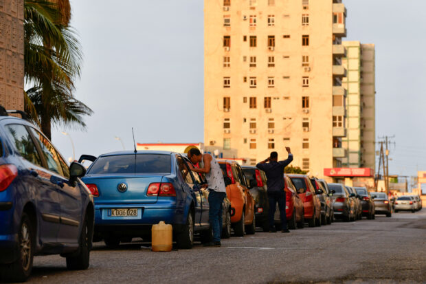 Drivers line-up to buy fuel at a gas station in Havana